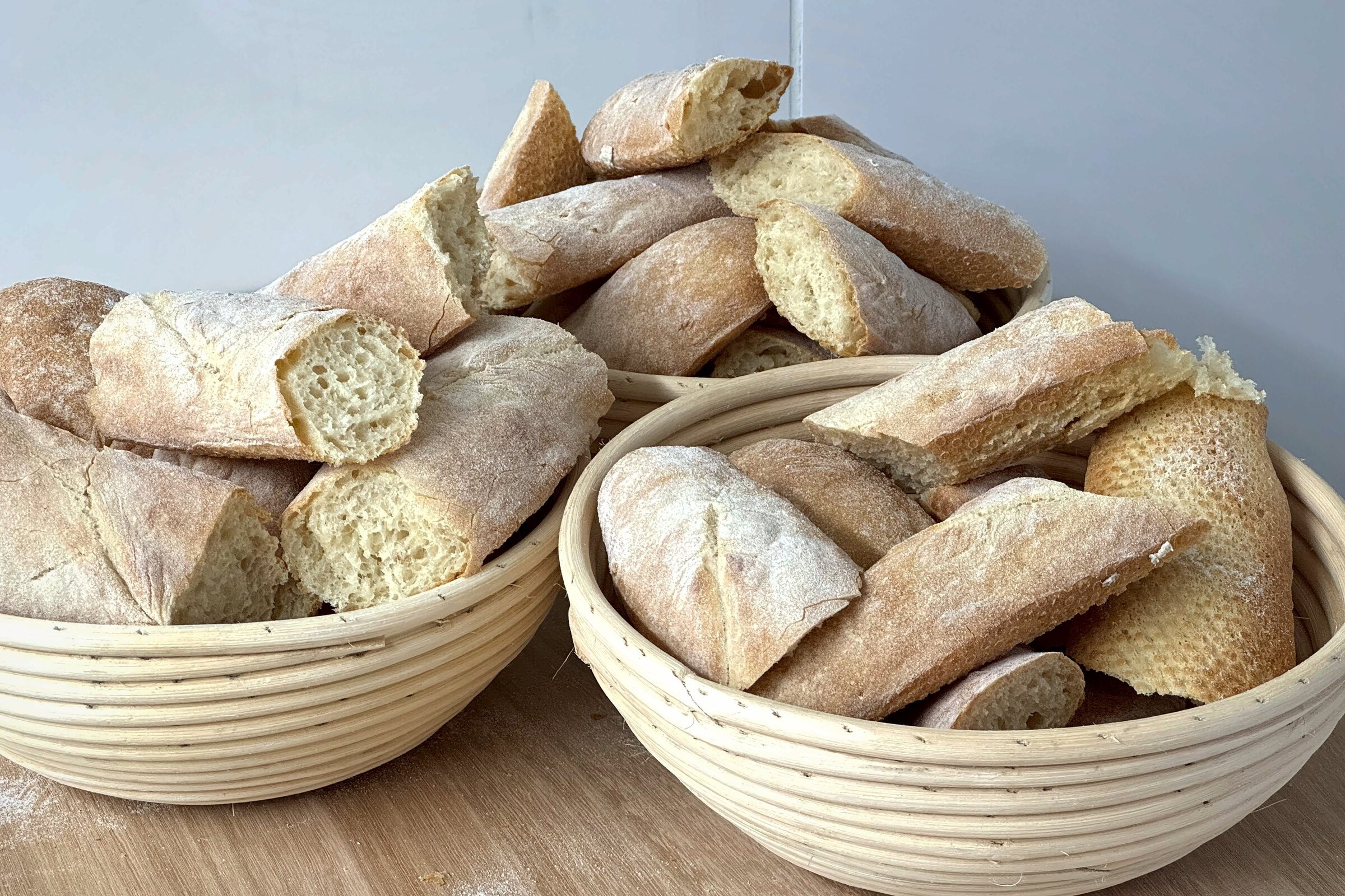 Baskets of freshly baked bread and baguettes at The Globe Bakery