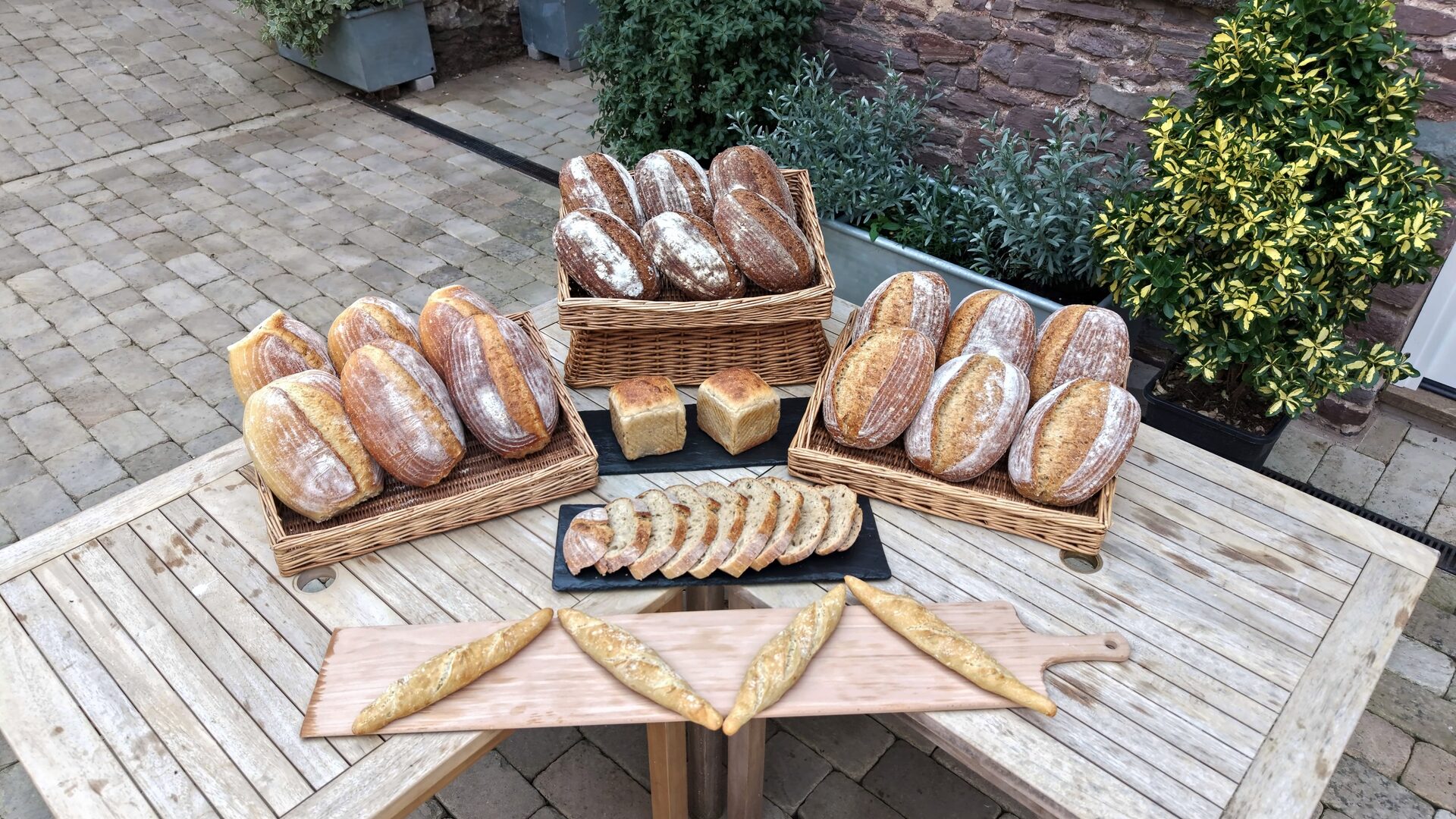 Fresh bread laid out in the stone courtyard at The Globe, Laugharne