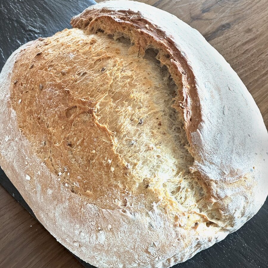An 8-grain loaf, split to show the seeded crumb