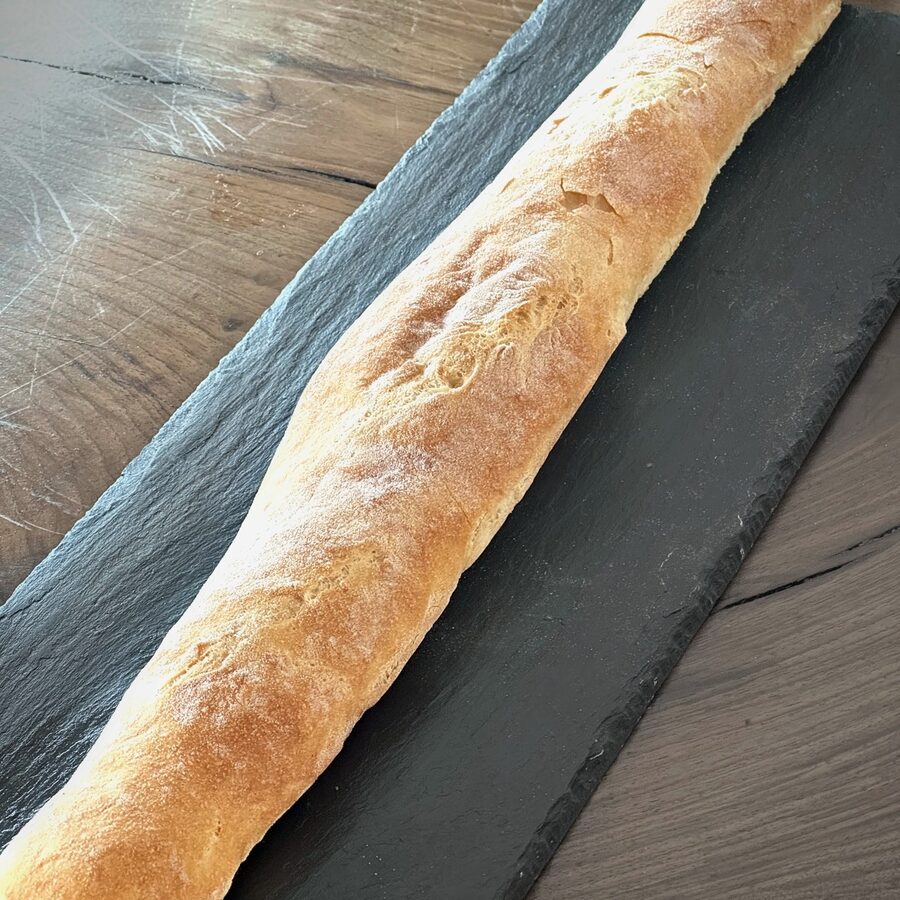 A full-length baguette on slate